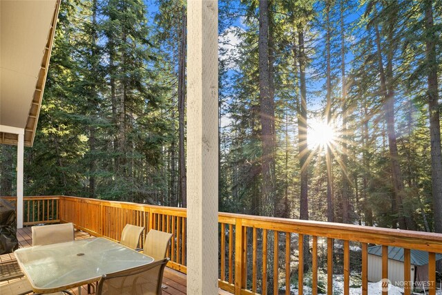 wooden terrace featuring outdoor dining area