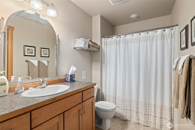 bathroom featuring toilet, a shower with curtain, vanity, and tile patterned floors