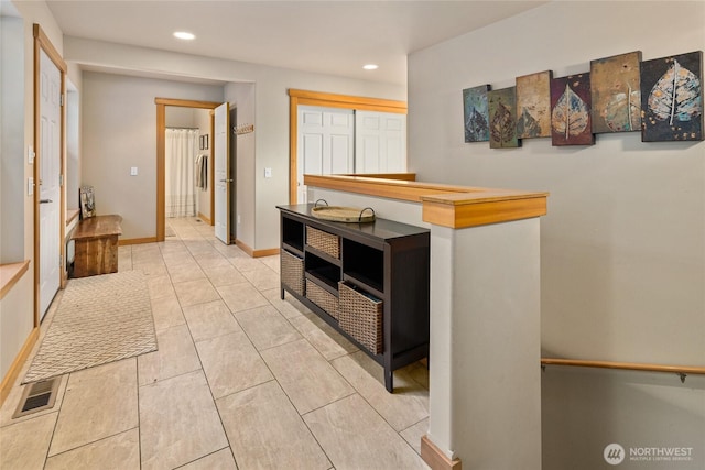 corridor with baseboards and recessed lighting