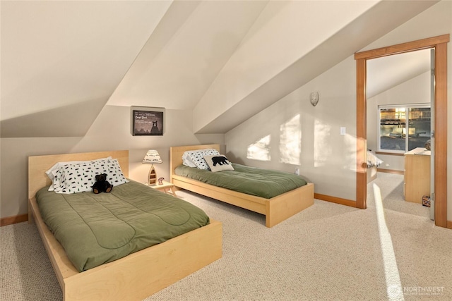 carpeted bedroom with lofted ceiling and baseboards