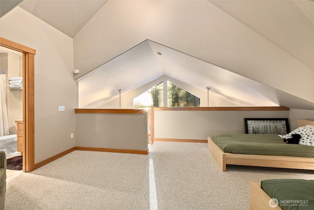 unfurnished bedroom with lofted ceiling and baseboards