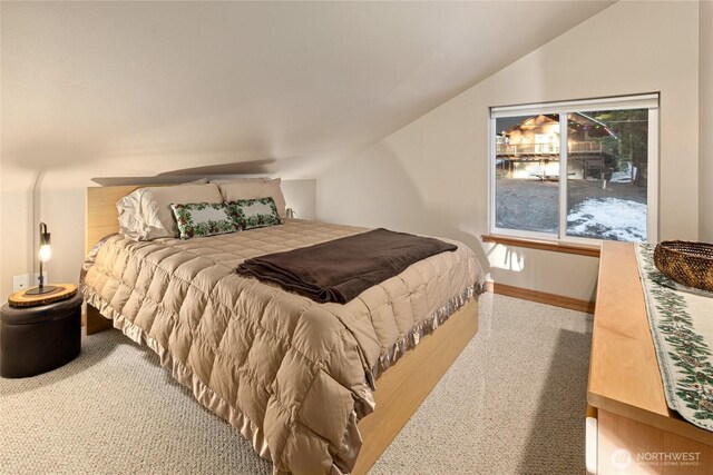 bedroom featuring vaulted ceiling and baseboards