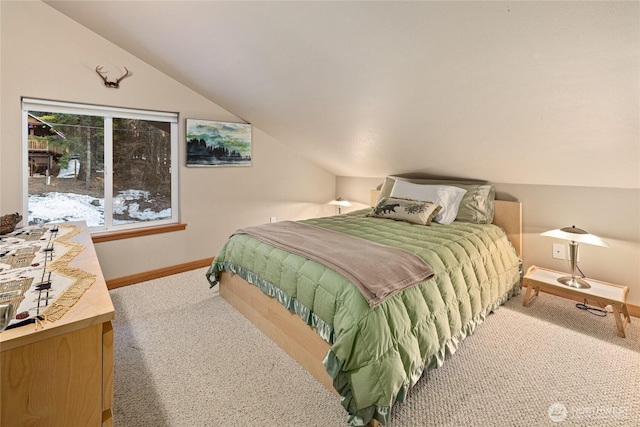 carpeted bedroom featuring vaulted ceiling and baseboards