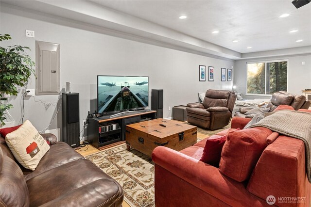 living area with light wood-style floors, electric panel, and recessed lighting