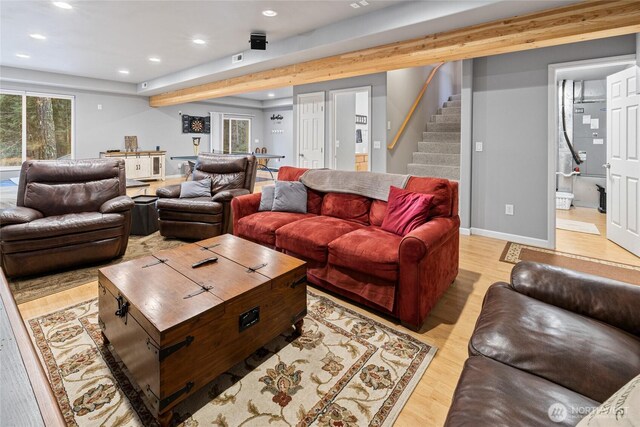 living area featuring light wood-style floors, stairs, baseboards, and recessed lighting