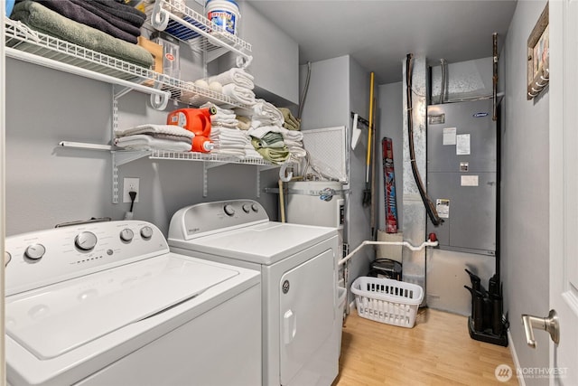 washroom with laundry area, washer and clothes dryer, and light wood-style floors