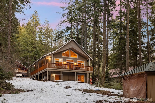 rustic home featuring a standing seam roof and a deck