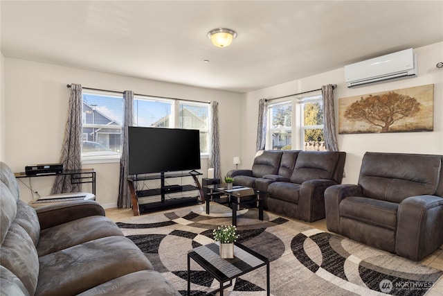 living area featuring baseboards and a wall mounted AC