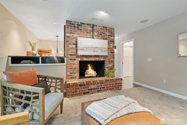 living room with a brick fireplace, light carpet, and baseboards