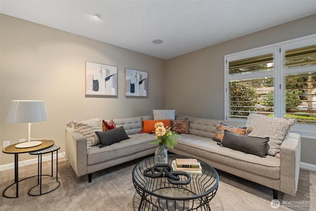 living room with light carpet and baseboards