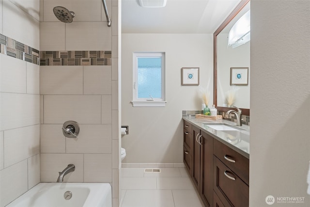 bathroom with toilet, visible vents, vanity, bathing tub / shower combination, and tile patterned floors