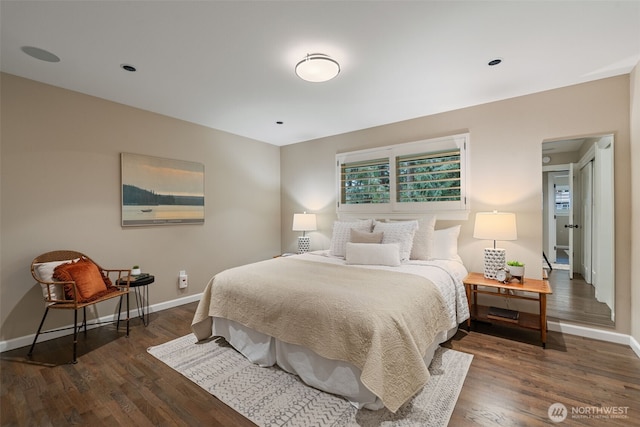 bedroom featuring baseboards and dark wood-type flooring