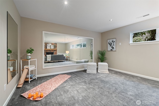 sitting room with recessed lighting, visible vents, dark carpet, a brick fireplace, and baseboards