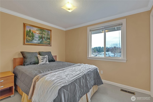 bedroom with ornamental molding, carpet flooring, visible vents, and baseboards