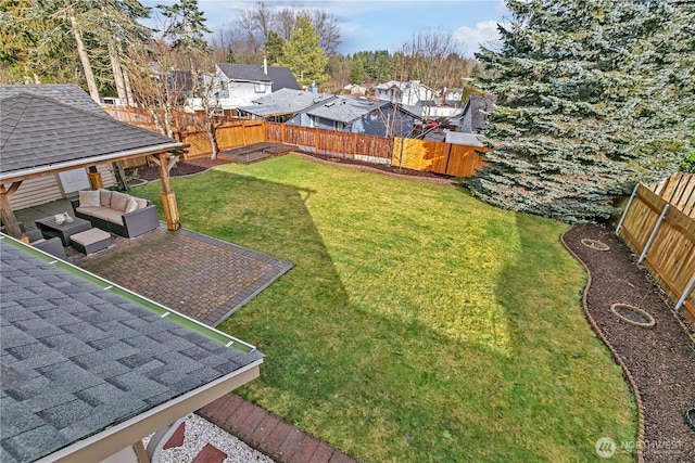 view of yard with a fenced backyard, a residential view, an outdoor living space, and a patio