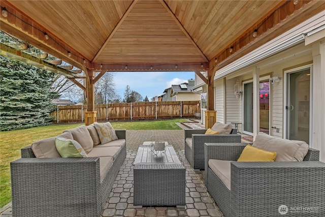 view of patio / terrace with outdoor lounge area, fence, and a gazebo