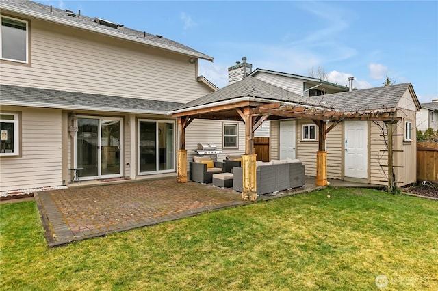 rear view of property with roof with shingles, a lawn, a patio area, fence, and an outdoor living space