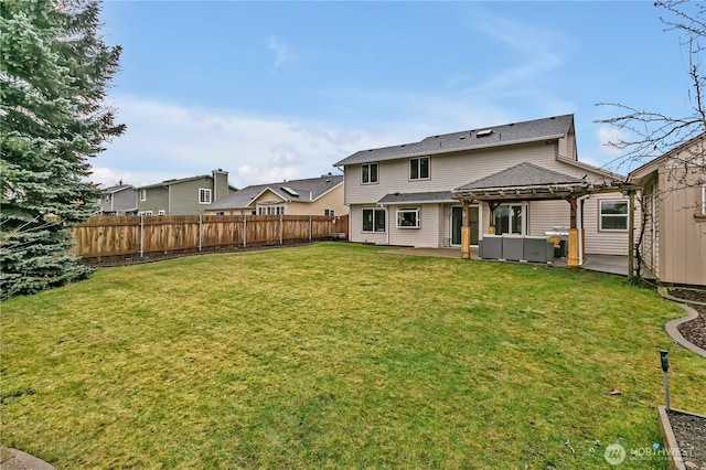 rear view of property featuring a patio area, a fenced backyard, and a lawn