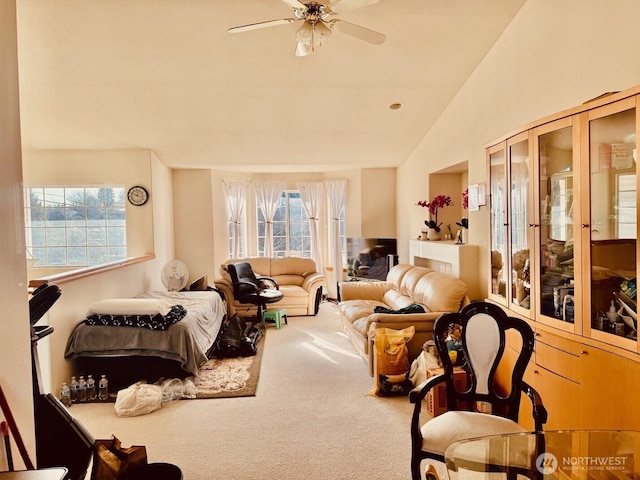 interior space featuring vaulted ceiling, ceiling fan, carpet flooring, and a wealth of natural light