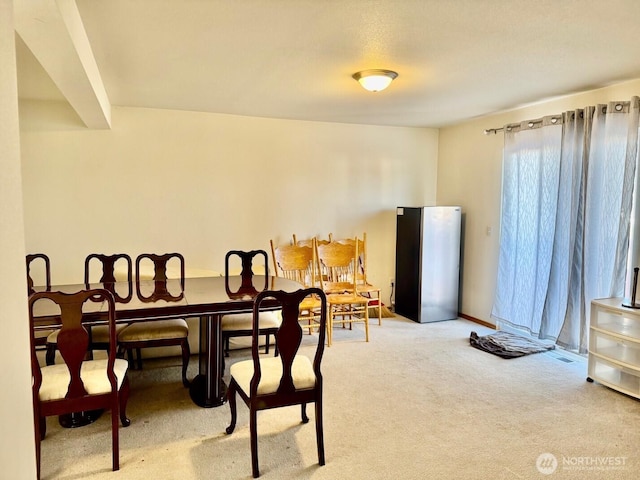 view of carpeted dining area