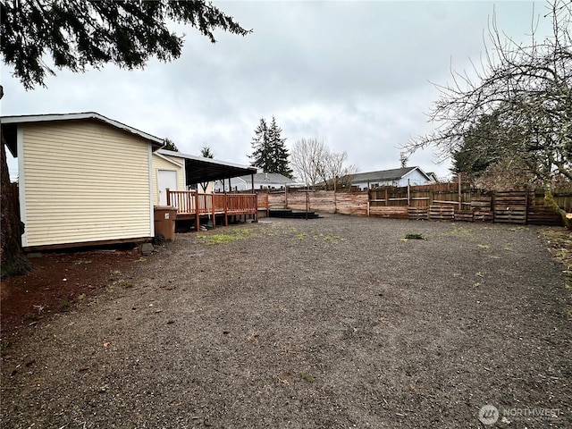 view of yard featuring fence and a wooden deck