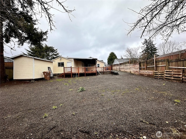 back of house featuring fence and a deck