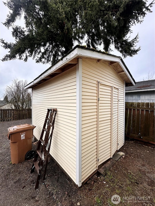 view of shed with fence