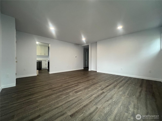 empty room featuring dark wood-style flooring, recessed lighting, and baseboards