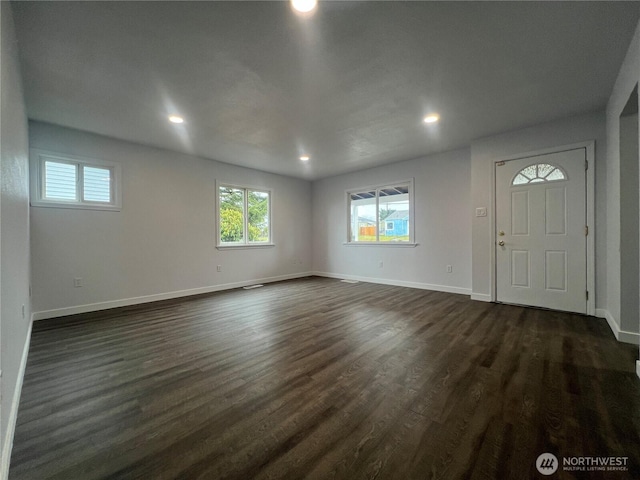 entrance foyer featuring dark wood-style floors, baseboards, and recessed lighting