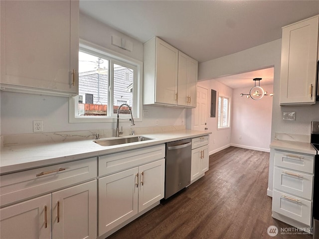 kitchen featuring appliances with stainless steel finishes, plenty of natural light, white cabinets, and a sink