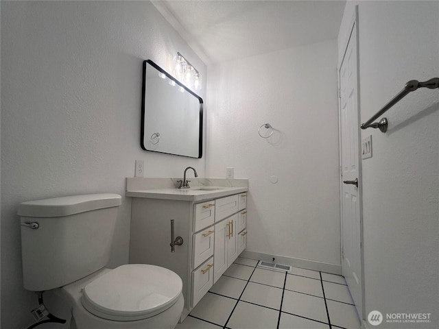 half bath with visible vents, baseboards, toilet, tile patterned flooring, and vanity