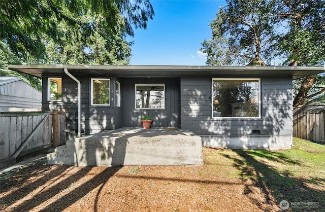 view of front of home featuring crawl space, a patio area, and fence