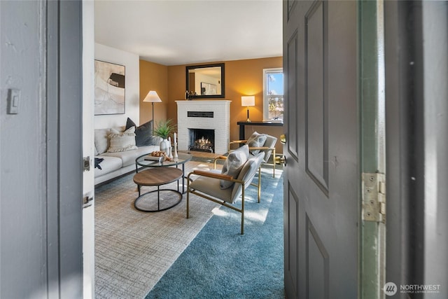 carpeted living area featuring a fireplace