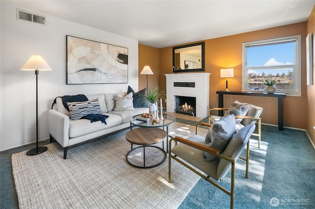 living area featuring a brick fireplace, carpet, visible vents, and baseboards