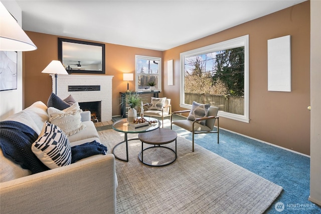 living room with a fireplace, baseboards, and carpet flooring