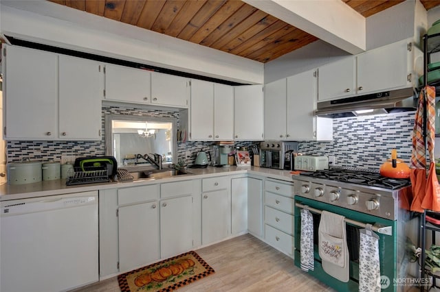 kitchen featuring dishwasher, light countertops, under cabinet range hood, stainless steel range with gas cooktop, and a sink