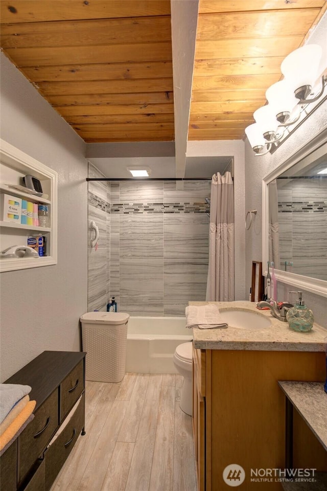 bathroom featuring toilet, wooden ceiling, wood finished floors, shower / bath combination with curtain, and vanity