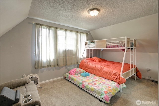 carpeted bedroom featuring vaulted ceiling, a textured ceiling, and baseboards