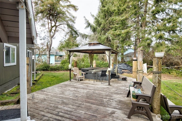 wooden deck with a lawn and a gazebo