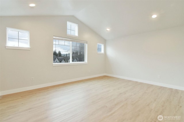 spare room with baseboards, vaulted ceiling, wood finished floors, and recessed lighting