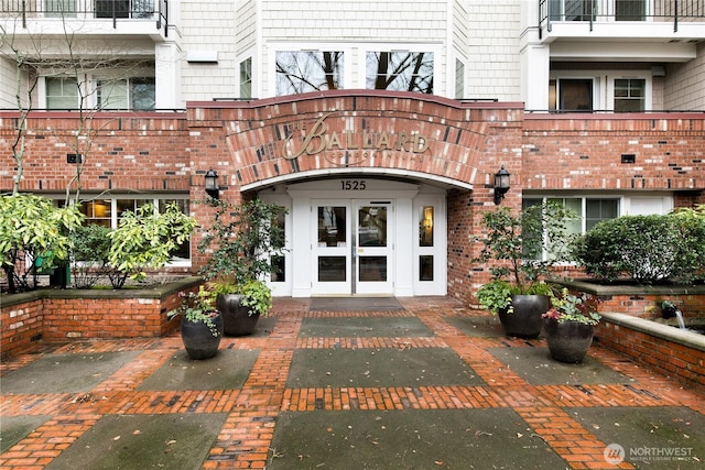 view of exterior entry featuring brick siding