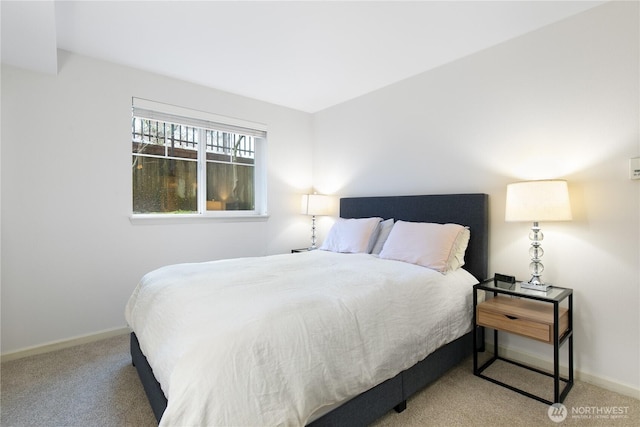 carpeted bedroom featuring baseboards