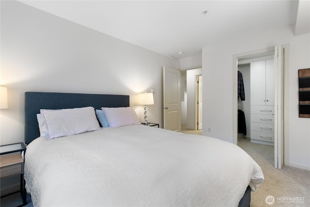 bedroom with light carpet and baseboards