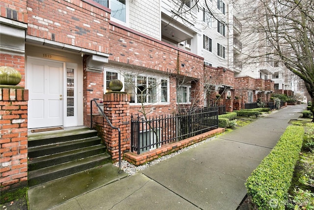 view of exterior entry with brick siding