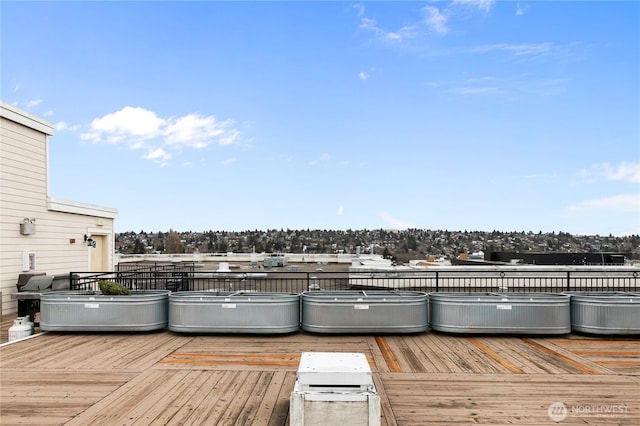 wooden terrace featuring a hot tub