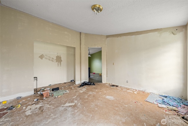 unfurnished room with a textured ceiling