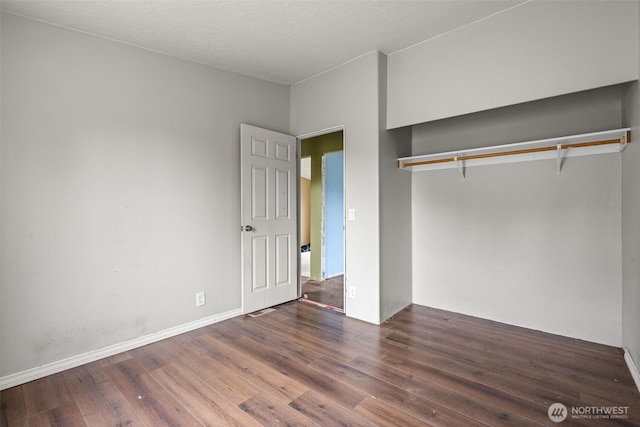 unfurnished bedroom with a closet and wood finished floors