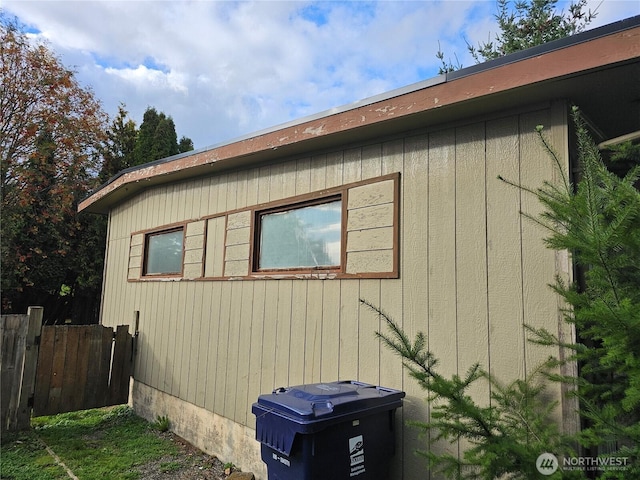 view of side of property featuring fence