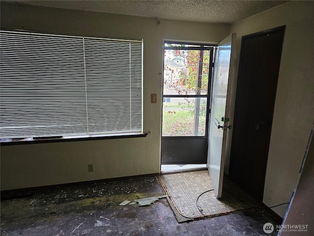 entryway with a textured ceiling