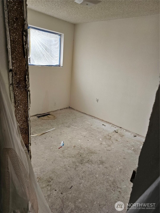 empty room featuring a textured ceiling